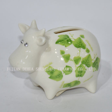 Vaca pequeña de cerámica con calcomanías verdes hucha